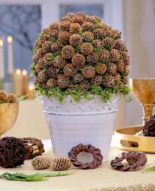 Pine cones in a pot on a table.