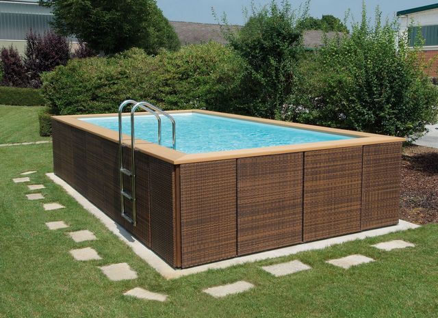 An outdoor swimming pool with a wooden deck.