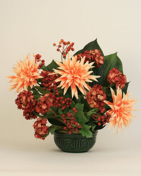 Dahlias and berries in a green vase.