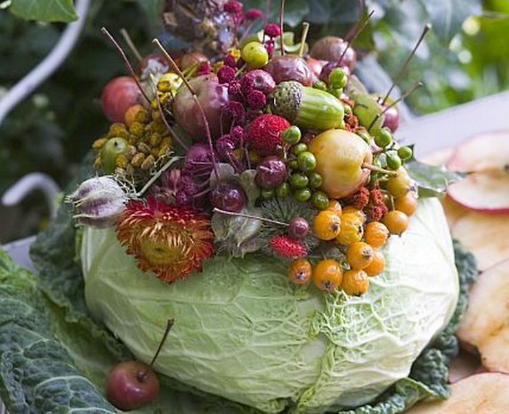 A cabbage with fruit on top of it.