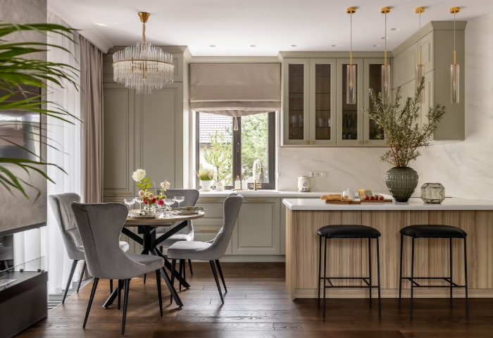 A modern kitchen with a dining table and chairs.