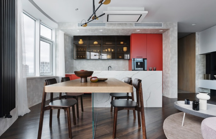 A modern apartment with a dining table and chairs.