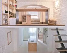 A small room with a loft and stairs.
