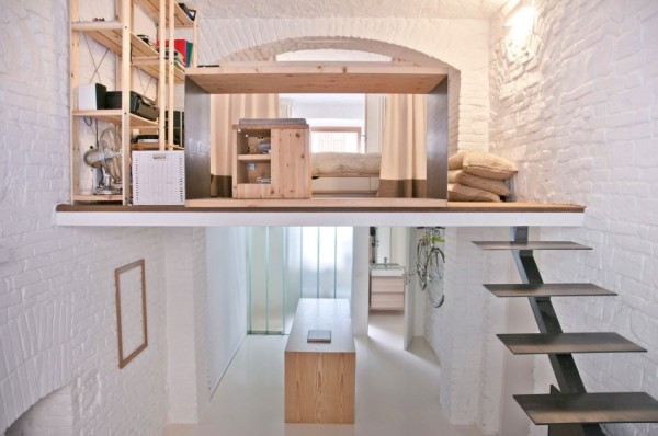 A small room with a loft and stairs.