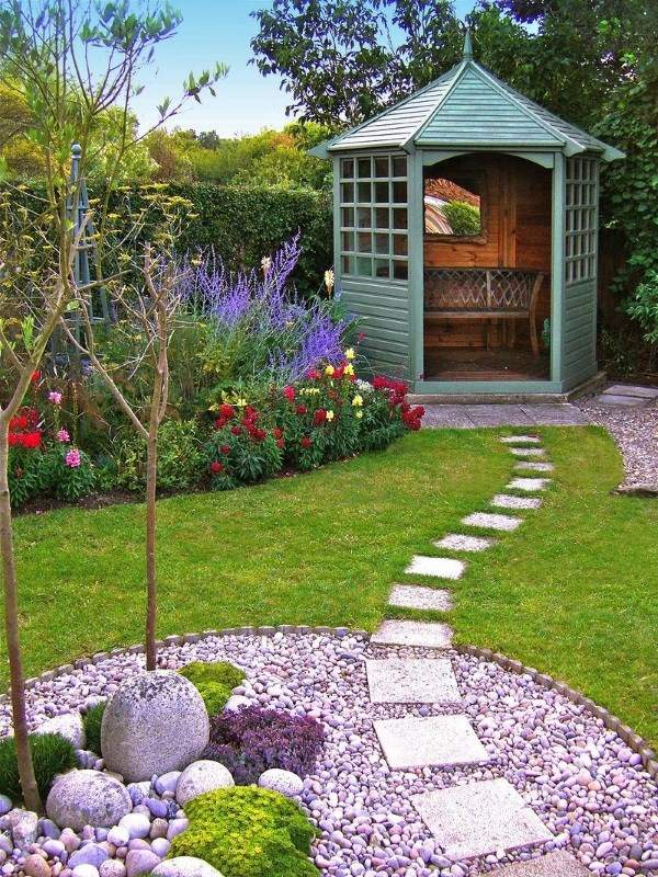 A small garden with a gazebo and pathway.