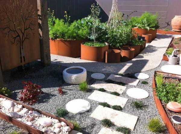 A garden with potted plants and stones.