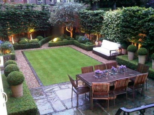 A small backyard with a lawn and furniture.