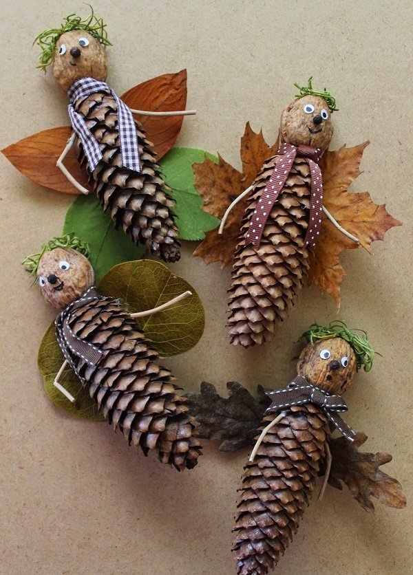 Four pine cone ornaments with leaves and leaves on them.