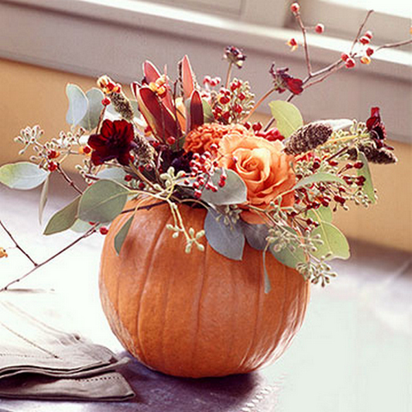 A pumpkin with flowers in it.