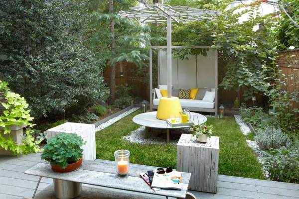 A small backyard with a table and chairs.