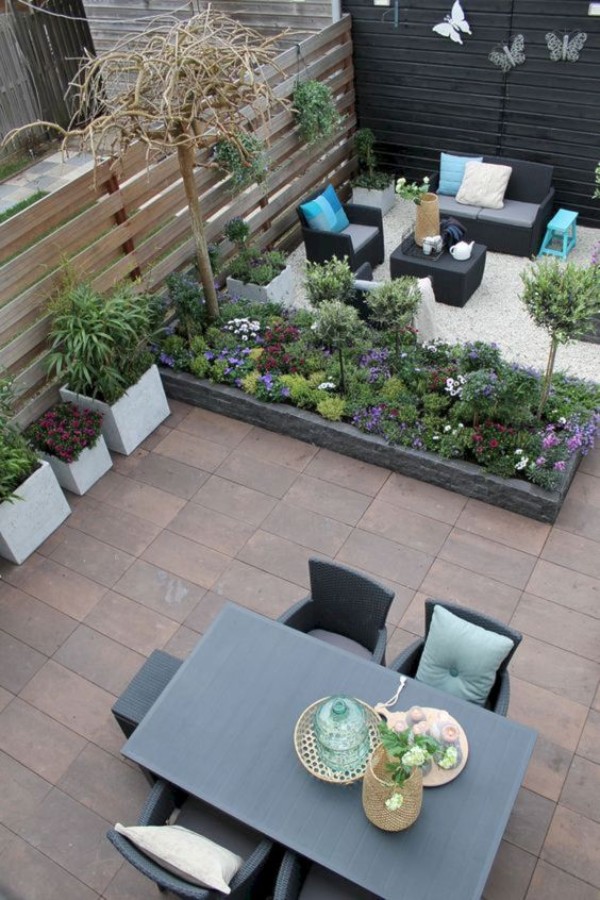 An outdoor patio with furniture and plants.