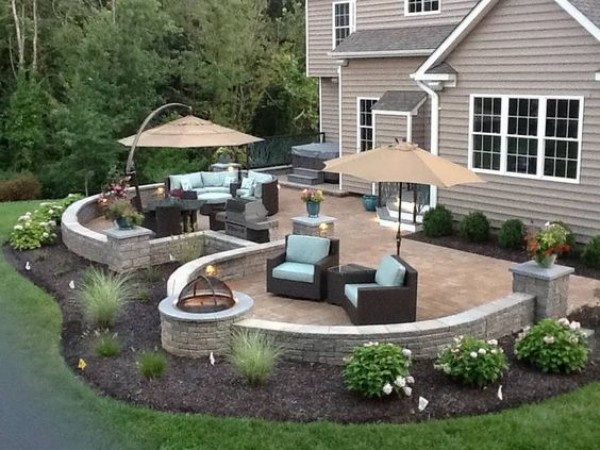 A backyard with patio furniture and a fire pit.