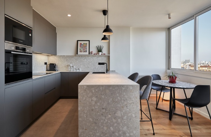 A modern kitchen with a view of the city.