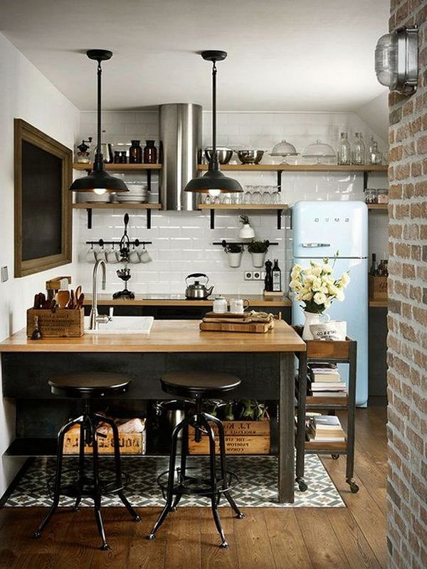 A kitchen with a wooden floor and a blue refrigerator.