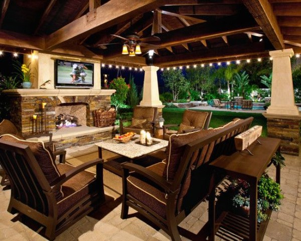 An outdoor living area with furniture and a tv.