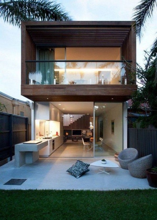 A modern house with a wooden deck and patio.