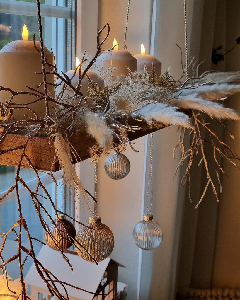 A wooden candle holder hanging from a window in a living room.