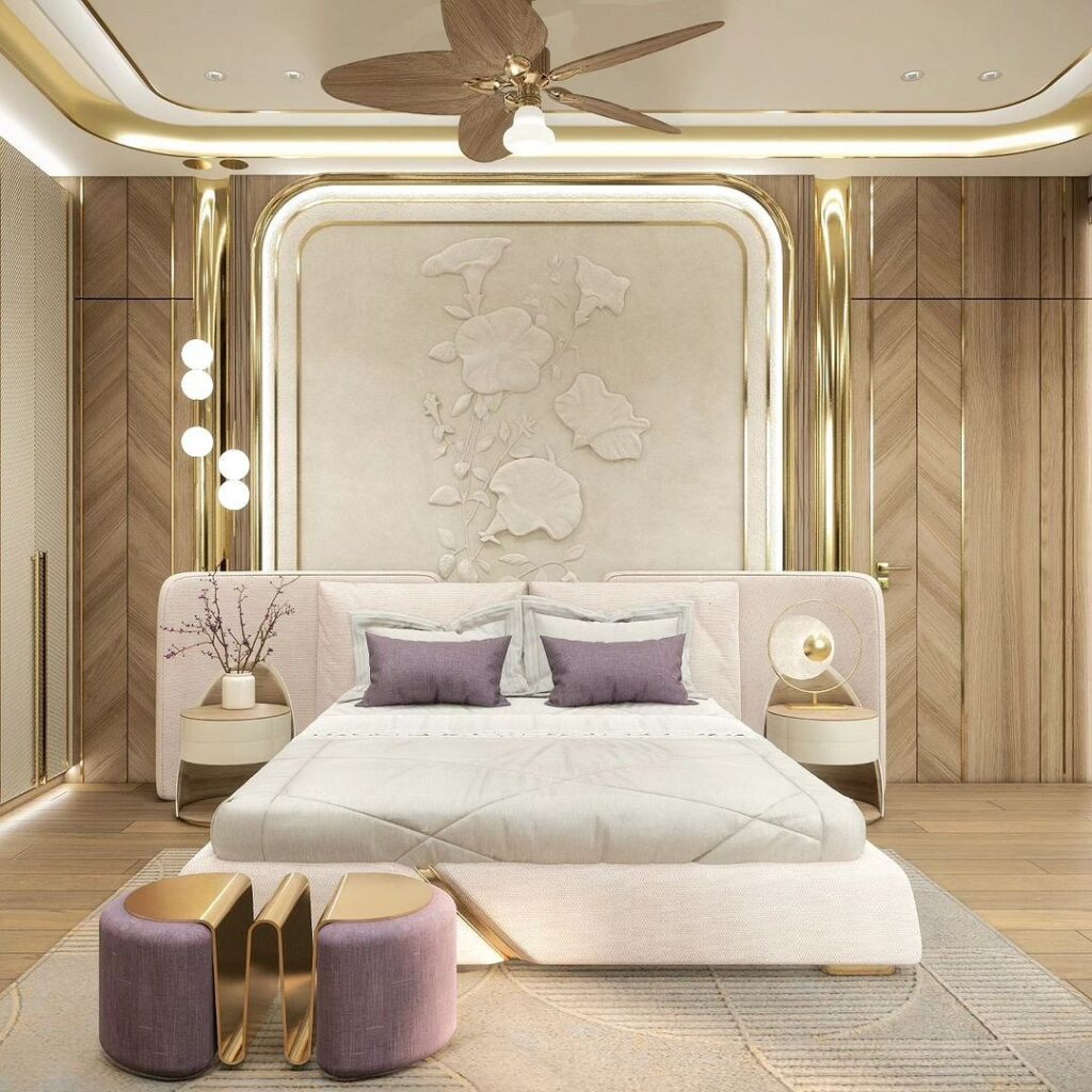 A modern bedroom with gold accents and a bed.