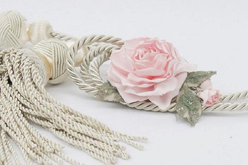 A tassel with a pink rose on it.