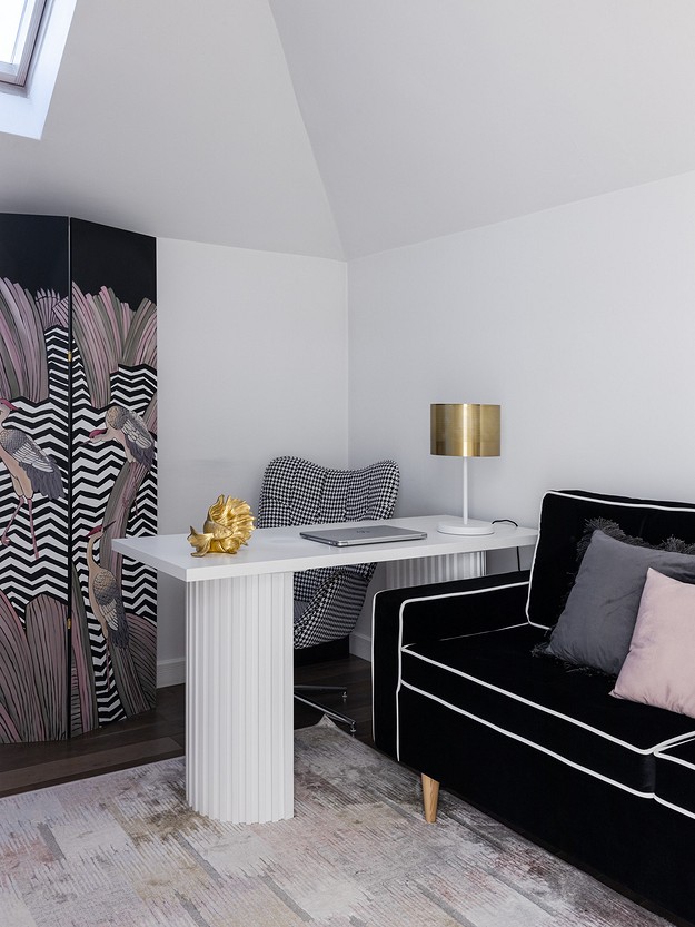 A black and white living room with a zebra print sofa.