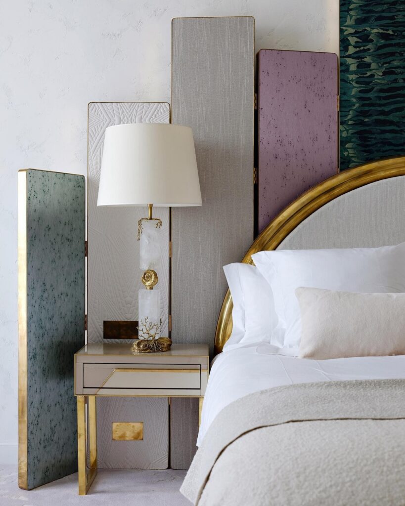 A bed in a room with a gold headboard.