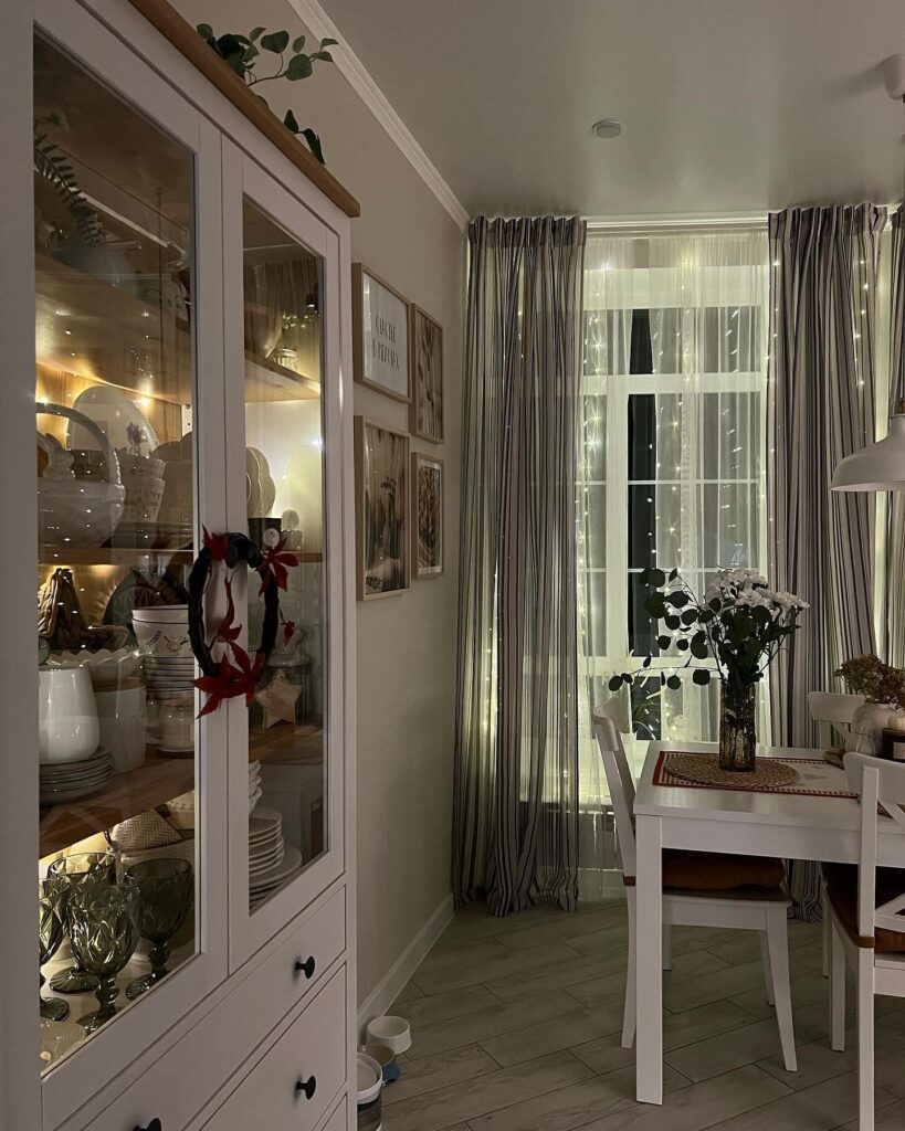 A dining room with a white hutch.