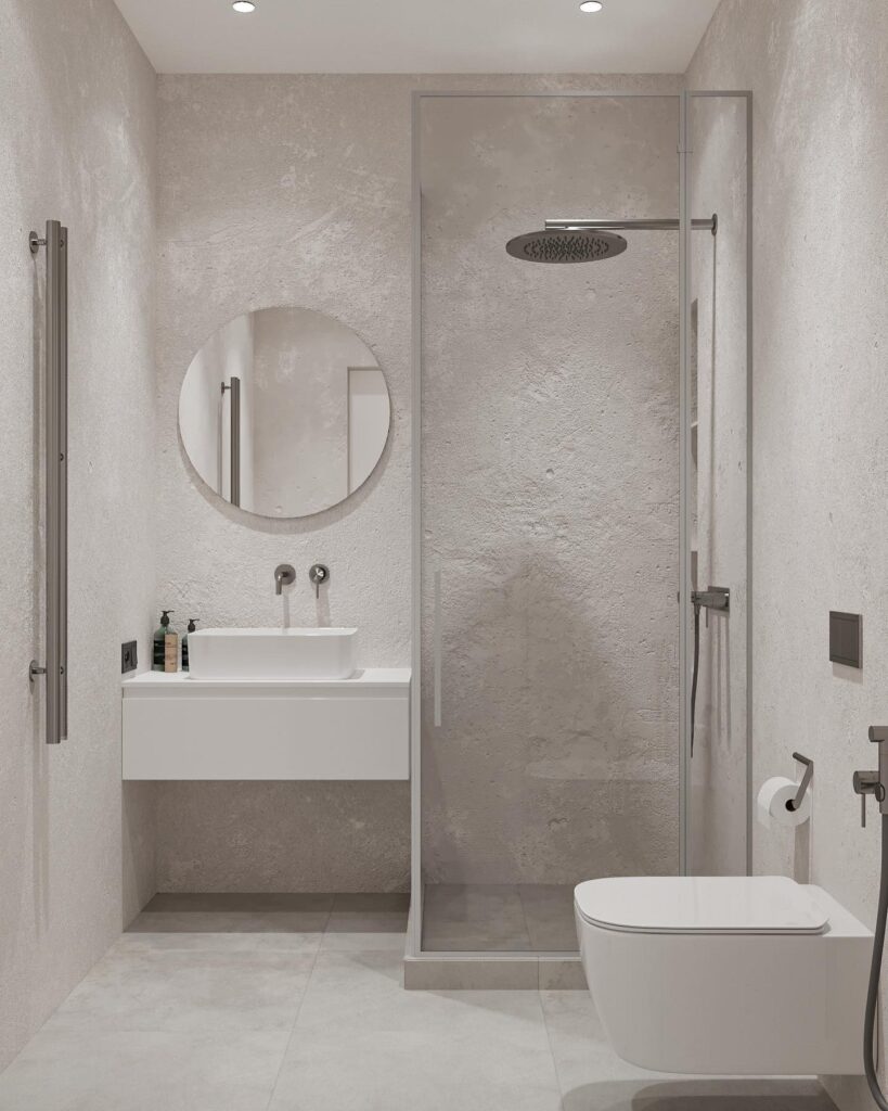 A white bathroom with a glass shower and toilet.