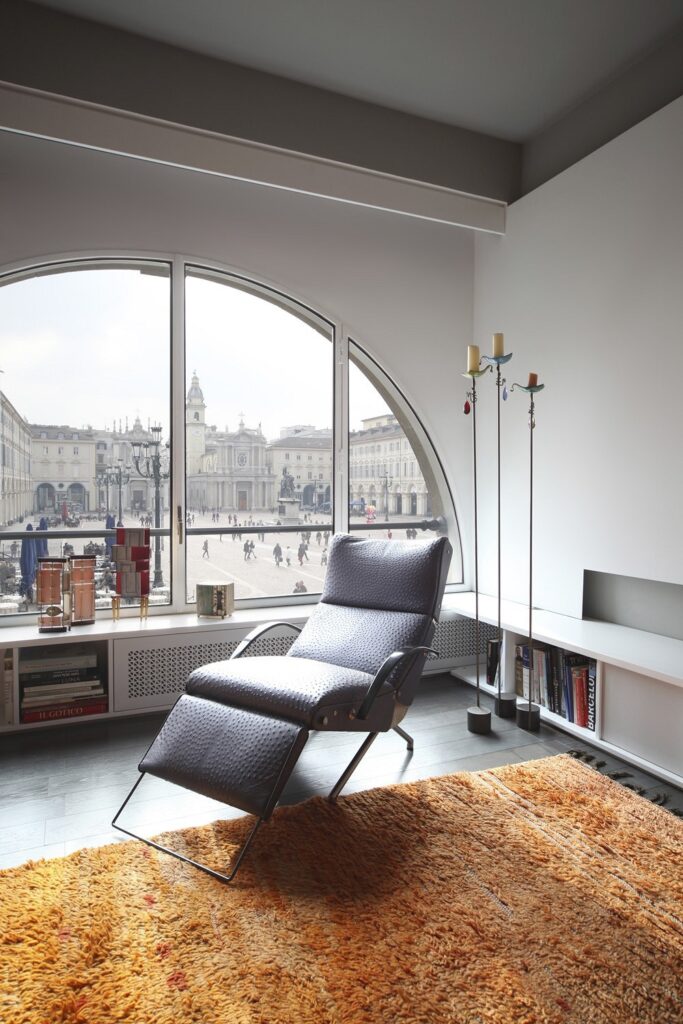 A chair in a room with a large window.