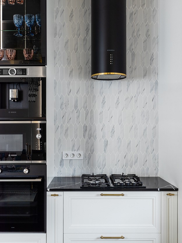 A black and white kitchen with a stove and oven.