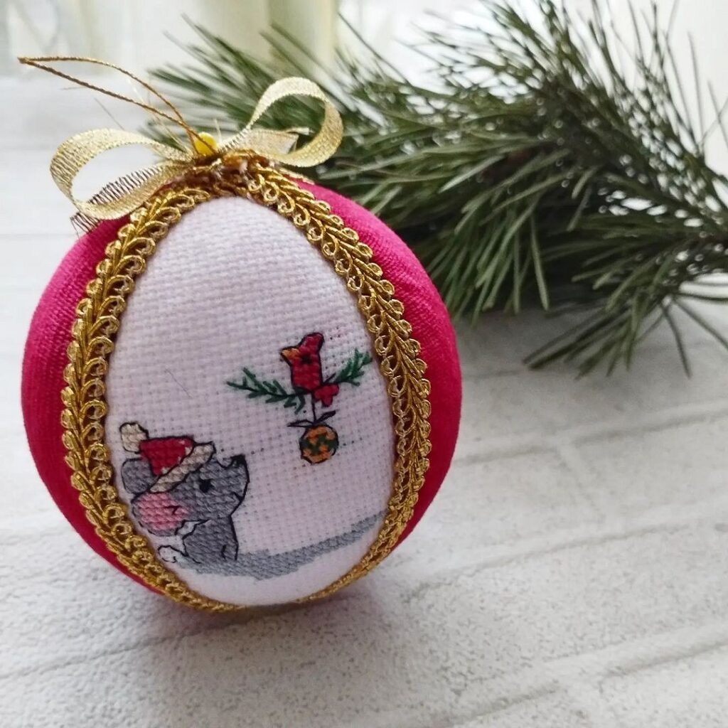 A christmas ornament with a mouse on it.