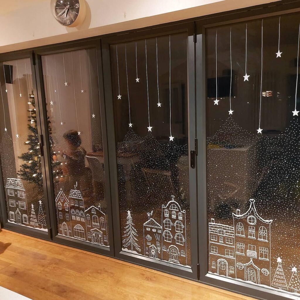 A glass door with a christmas scene on it.