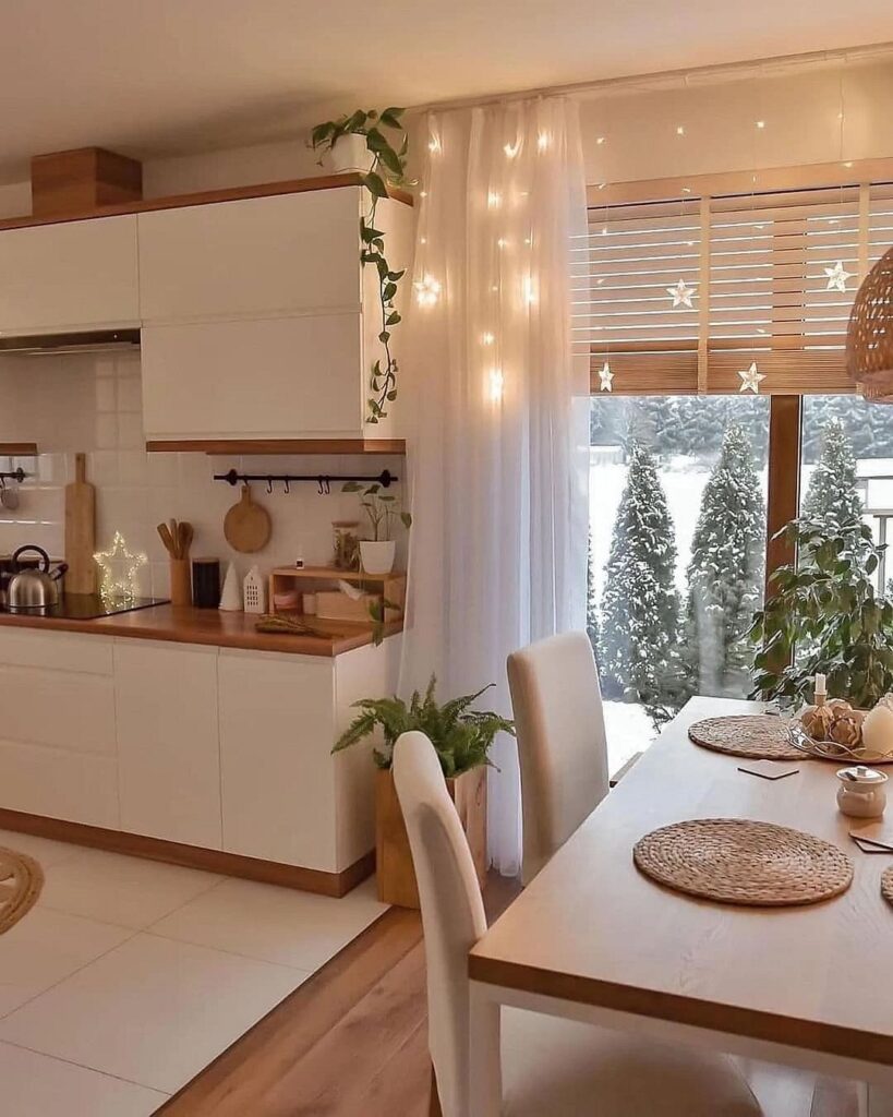 A white kitchen with a dining table and chairs.