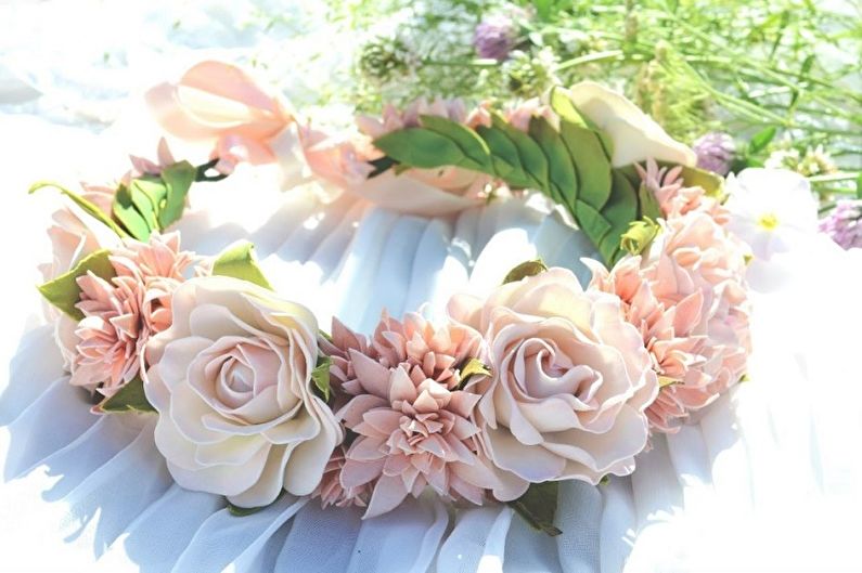 A pink flower crown on a white cloth.