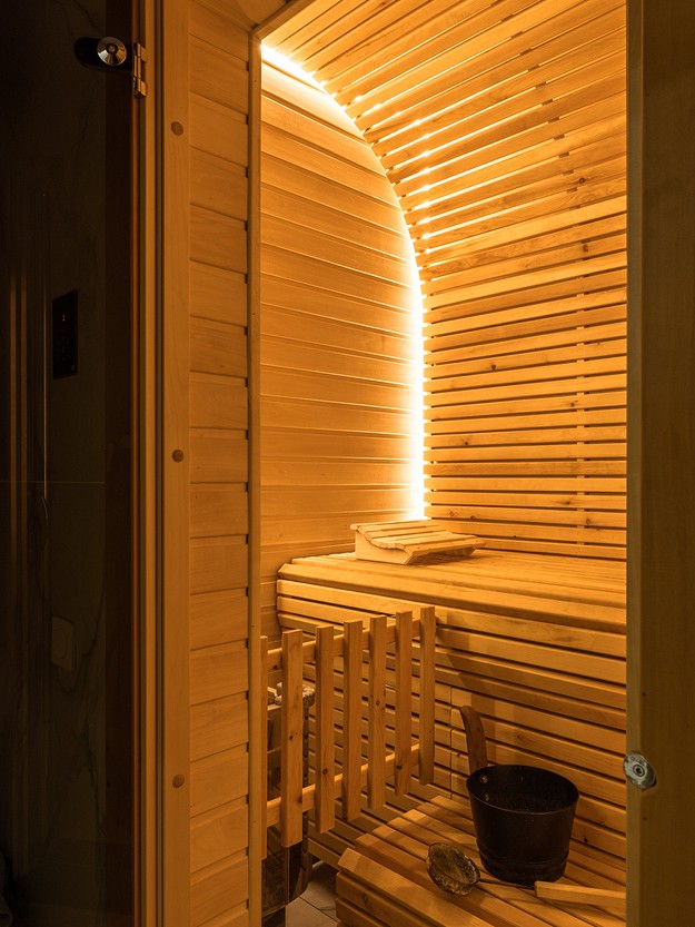 A wooden sauna room with a wooden floor.