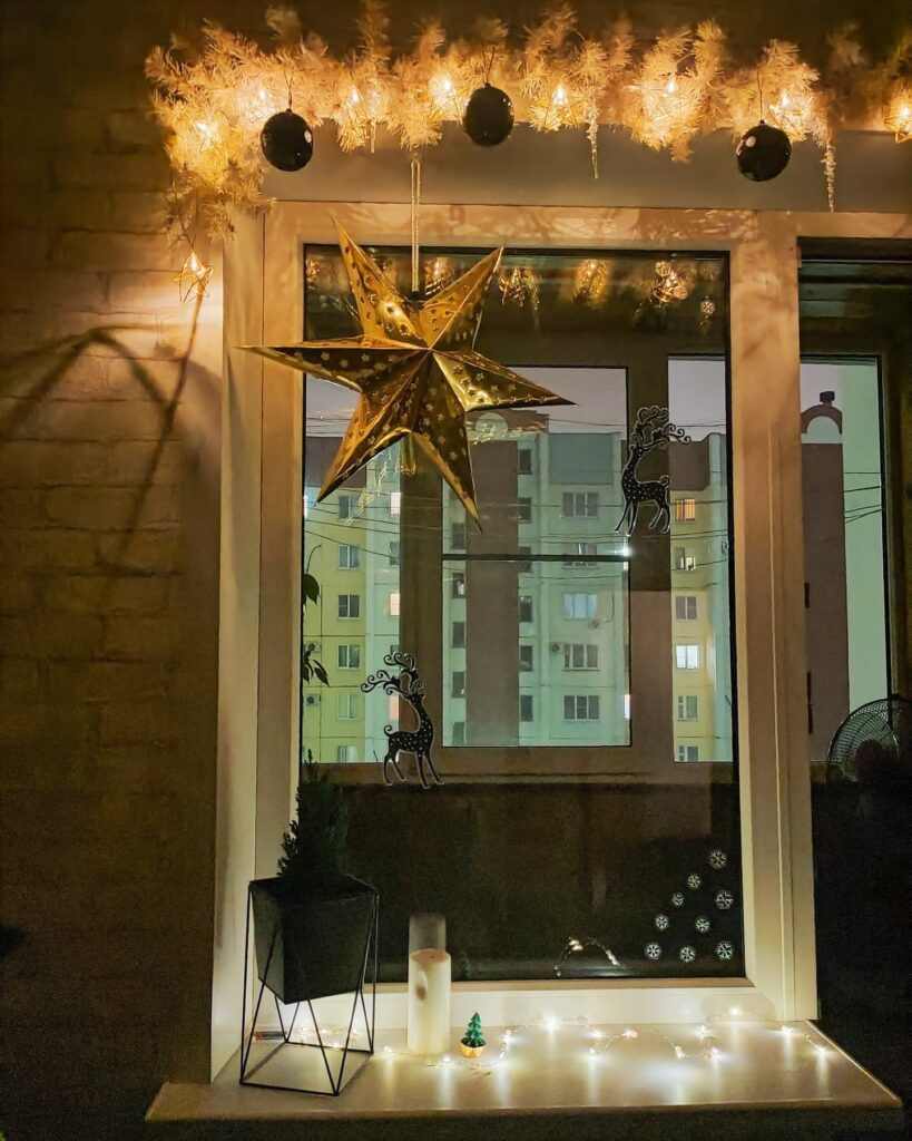 A window sill decorated with lights and a star.