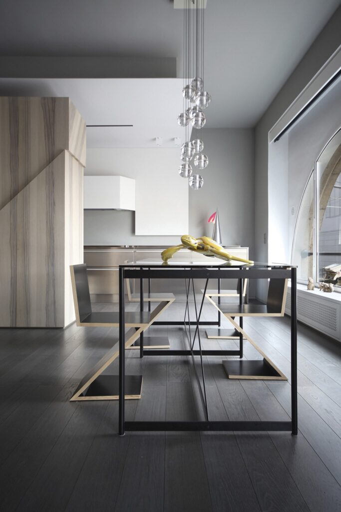 A dining room with a wooden table and chairs.