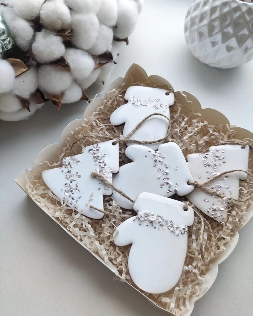 White mitten cookies in a box with cotton.