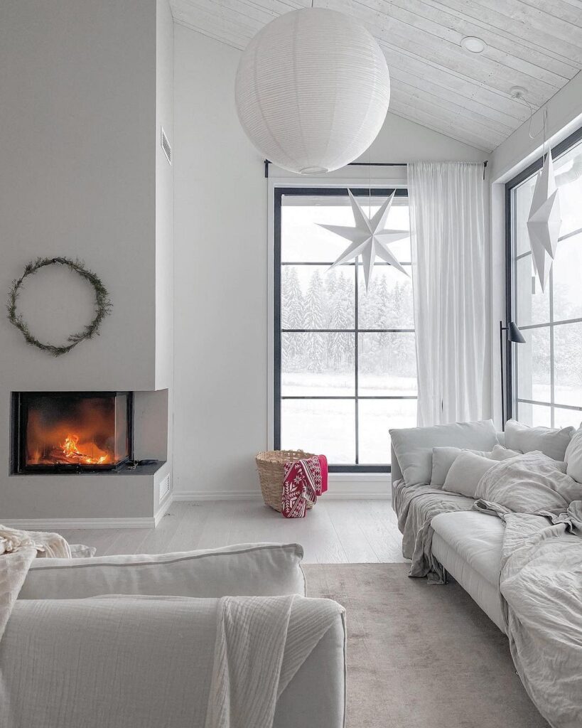 A white living room with a fireplace.