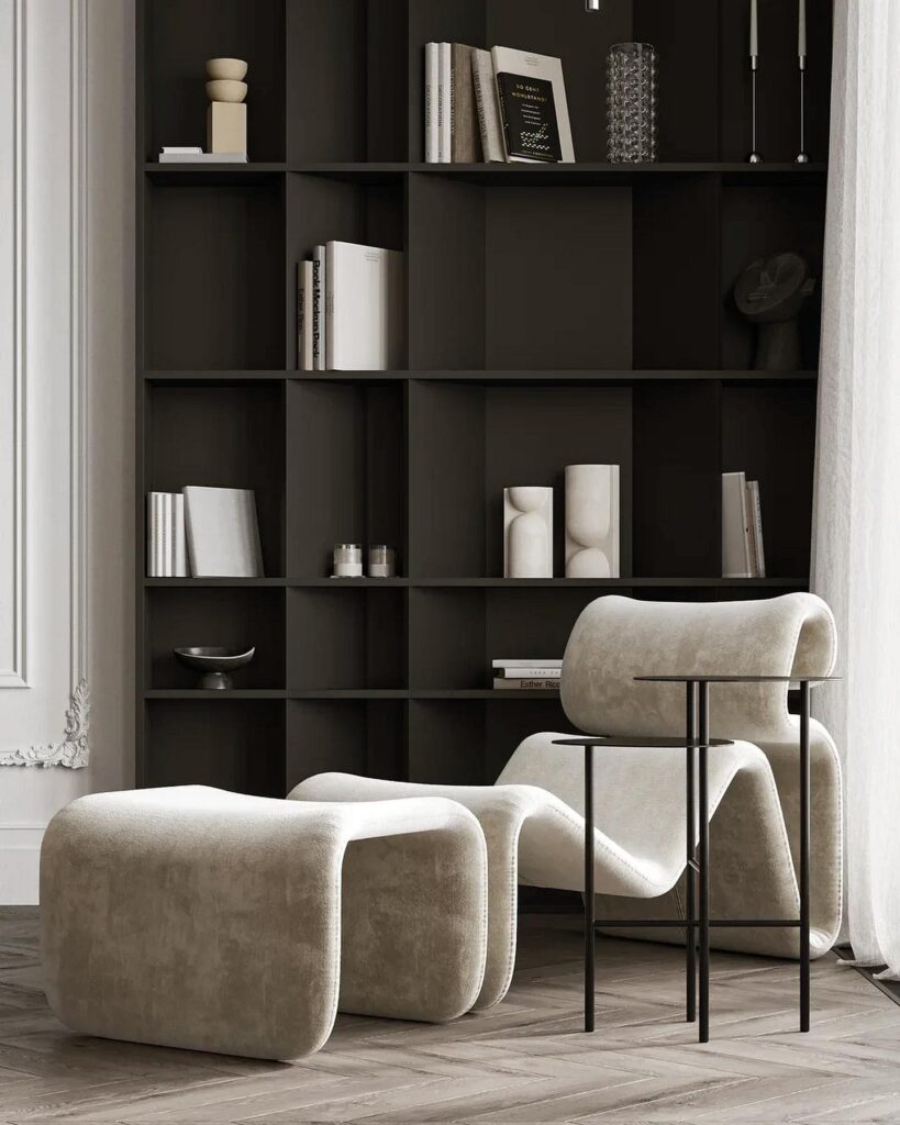 A room with a black bookcase and a white chair.