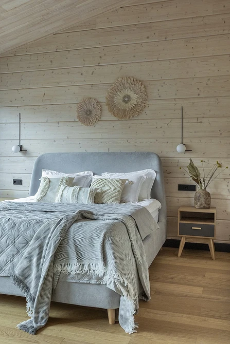 A bedroom with wooden walls and wooden floors.