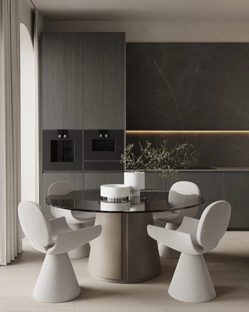A modern kitchen with a round table and chairs.
