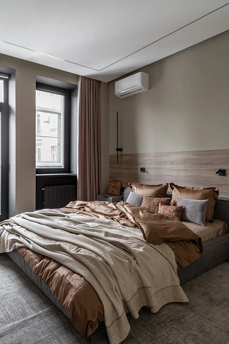 A bedroom with a large bed and a large window.