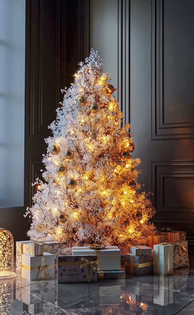 A white christmas tree in a room with presents.