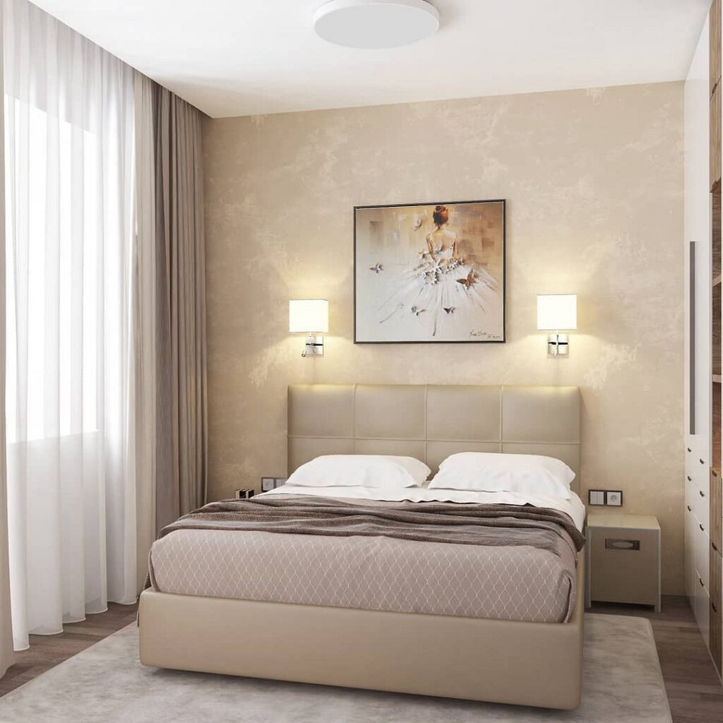 A bedroom with beige walls and a beige bed.