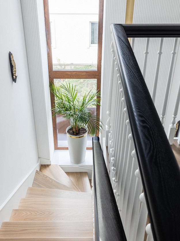 A wooden staircase with a potted plant on it.