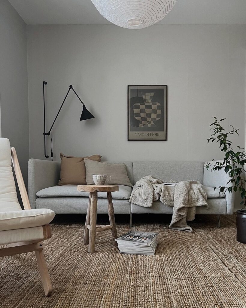 A living room with a rug and a chair.