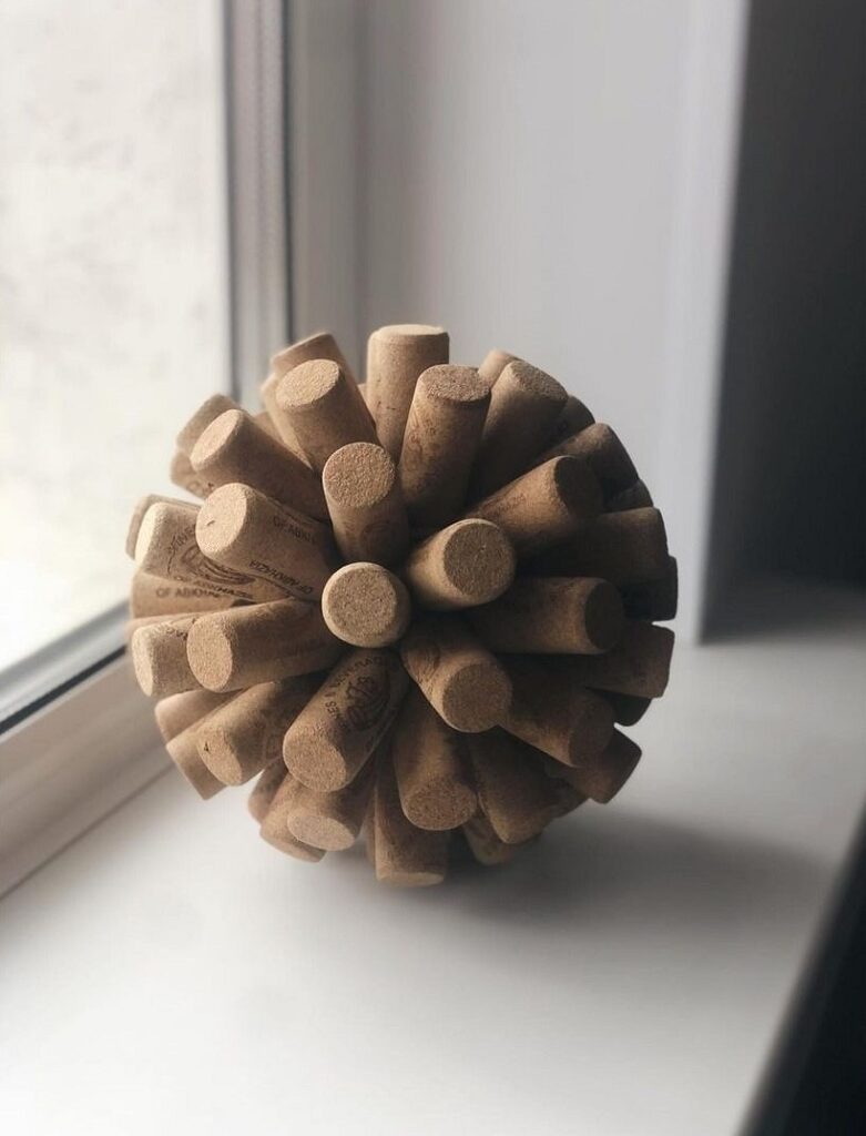 A wooden ball sitting on a window sill.