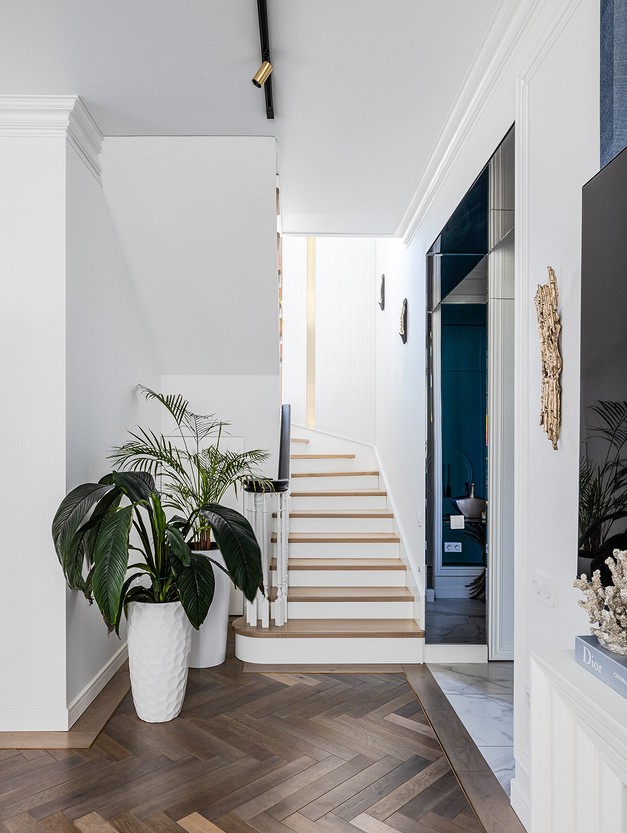 A hallway with wooden floors and a tv.