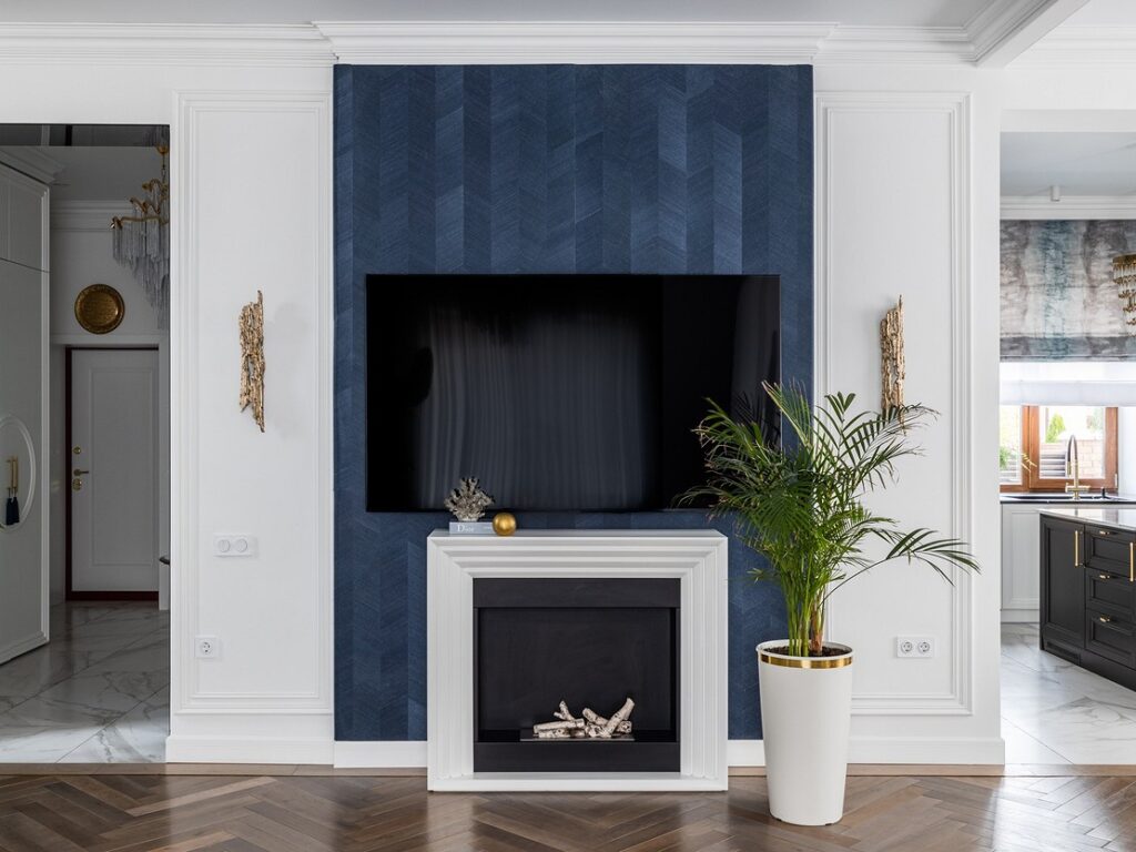 A living room with blue walls and a fireplace.