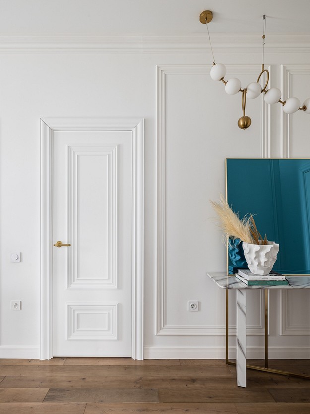 A living room with white walls and wooden floors.